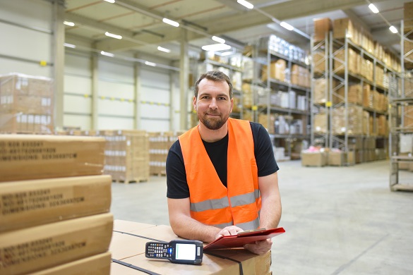 warehouse worker in a forwarding agency – interior with forklift – transport and storage of goods